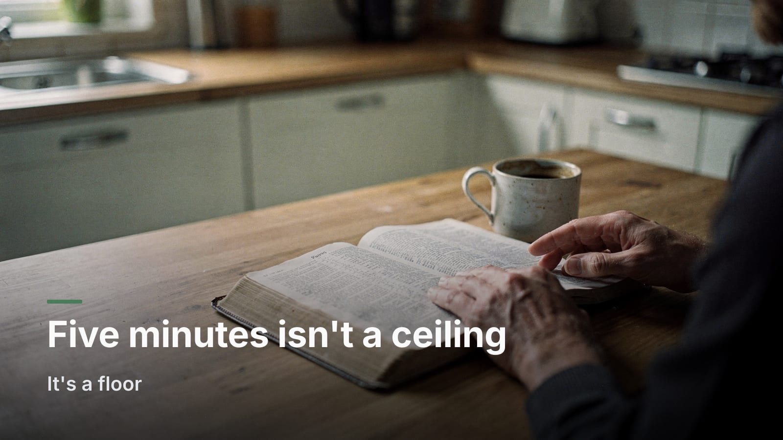Open Bible on a kitchen table in morning light with a coffee mug and hands resting on the page
